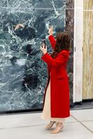 Architect taking pictures of marble slabs with smartphone in showroom photo