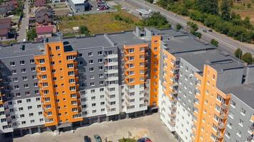 Block of flats in the city. Construction of a new apartment building. Modern high-raised building with colorful walls of residential complex. video