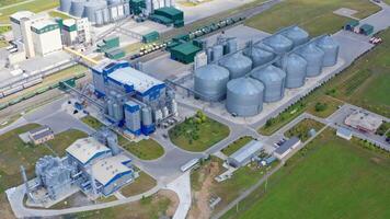 Modern factory at sunlight. Grain drying complex with metal terminals for keeping crop. New granary on field. View from the air. video