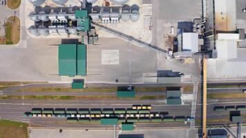 Plant for storage and processing of grain. Flight over silo system tanks. Metal grain bins on a modern agricultural factory. Aerial view. video