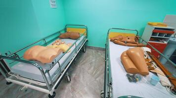 Mannequin models in hospital beds. Plastic dummy parts of patient's body to perform practice exercises in training room in the university. Faculty of health. video