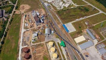 Construction of new granary on field. Abandoned industrial territory. Building new grain elevators. Aerial view. video
