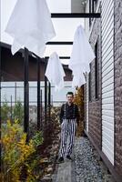 An Ethereal Scene Featuring Striped Attire and Floating Fabrics in a Beautiful Environment photo