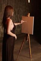 Artistic Expression A Woman Engaged in the Process of Painting in a Studio Setting photo