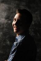 A Portrait of a Smiling Young Man Captured in Unique and Creative Lighting SetupA Striking Visual photo