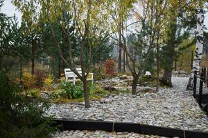 A Tranquil Autumn Garden featuring beautifully designed Pathways and comfortable Seating photo