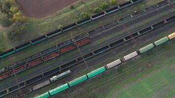 An aerial drone view of a diesel locomotive pulling railway carriages video