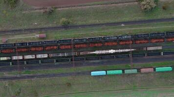 An aerial drone view of freight wagons at the station surrounded by fields video