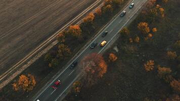 An aerial view of autumn traffic on the highway during a sunset. video