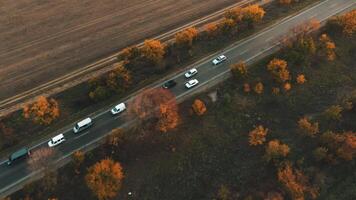 An aerial view of traffic on a road during autumn sunset. video