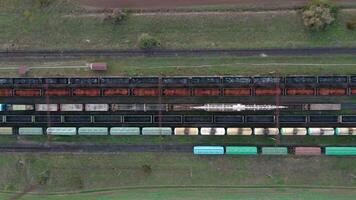 An aerial drone view of a locomotive pulling railway carriages video