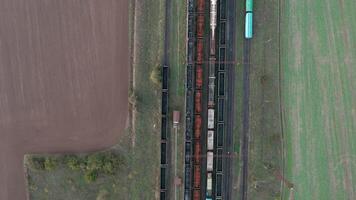 An aerial drone view of railway carriages at the station surrounded by fields video