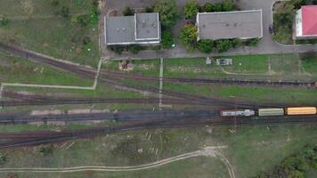 An aerial drone view of a rail freight train moving through the station video