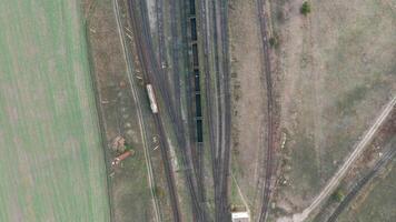 An aerial drone view of a diesel locomotive going to station video