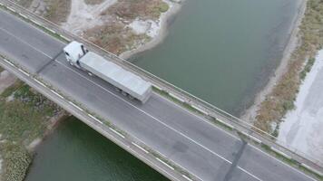 An aerial drone view of cars driving over the bridge. video