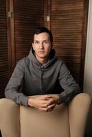 A Contemplative Portrait Set in a Modern Environment with Various Artistic Elements photo