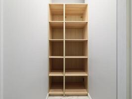 A Simple Wooden Shelf Unit featuring Compartments designed specifically for Storage purposes photo