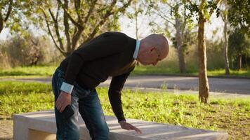 Old Man Sits on a Park Bench to Check His Smartphone video