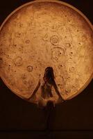 Experience an incredibly captivating view of a stunning celestial body with a figure above it photo