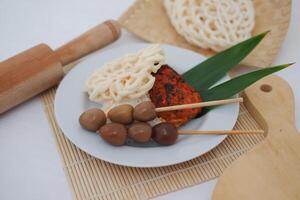 Delicious Indonesian Satay with Quail Eggs and Kerupuk photo