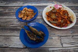 Homemade seafood with spicy fried shrimp and fried fish. photo