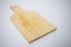 Natural wood chopping board with a handle, ideal for slicing vegetables or serving cheese. photo