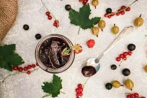 assortment of jam, seasonal berries of black, red currant, gooseberry and raspberry 7 photo