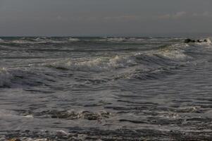 Waves in the Mediterranean Sea near beach in Cyprus photo