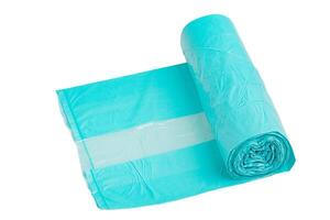 Garbage bags in a roll, turquoise color, isolate. Recycled material, garbage bag on a white background photo