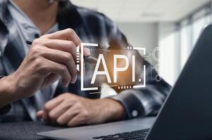 Person Programming API Interface on Laptop with Digital Overlay photo