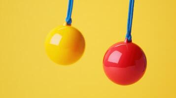 Two colorful balls hanging by strings photo