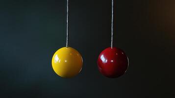 Two colorful balls hanging from strings photo