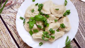Appetizing dumplings with potatoes and onions on a rustic table video