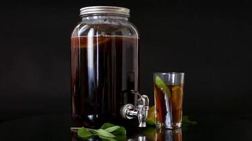 Refreshing kombucha in a glass jar and a glass with lime . video