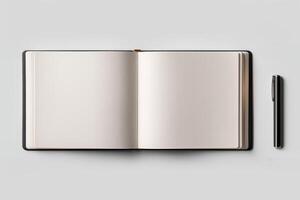 Open notebook with pen on a gray background, ready for writing. photo
