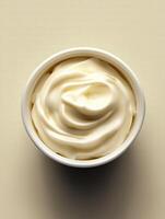 White container of cream is sitting on a table photo
