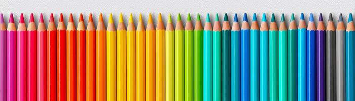 Colorful rainbow pencils neatly lined up on white background. photo