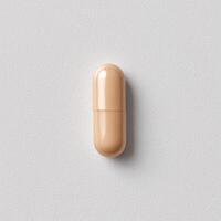 Minimalist beige capsule on textured white surface, top view. photo