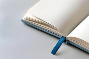 Open journal with a bookmark on a white background. photo