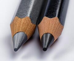 Close-up of two sharpened pencils on white background. photo