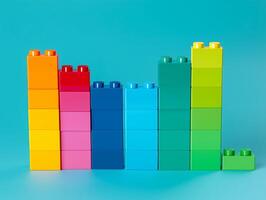 Stack of colorful blockwith the bottom row being red photo