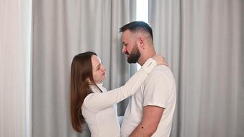 Loving couple hugging closely, man within woman expressing intimate connection and cozy residential in home video