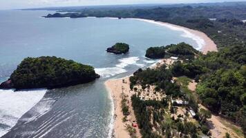 Reverse Drone View of Curved Coastline and Tropical Islets, East Java, Indonesia video