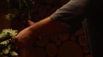 Hands Of Bath Attendant Steaming Male Visitor By Oak Brooms In Bathhouse, Closeup View video