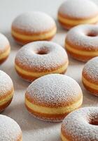 A bunch of powdered donuts on a table photo