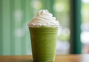 A green smoothie with whipped cream on top photo