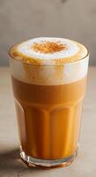 A coffee drink in a glass on a table photo