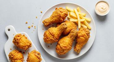 A plate of fried chicken and fries photo