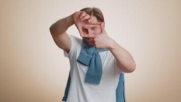 Man photographer making picture frame with hands focusing on interesting moment cropping nice image video