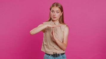Tired upset young woman showing time out gesture, limit or stop sign, bored of work, take a break video